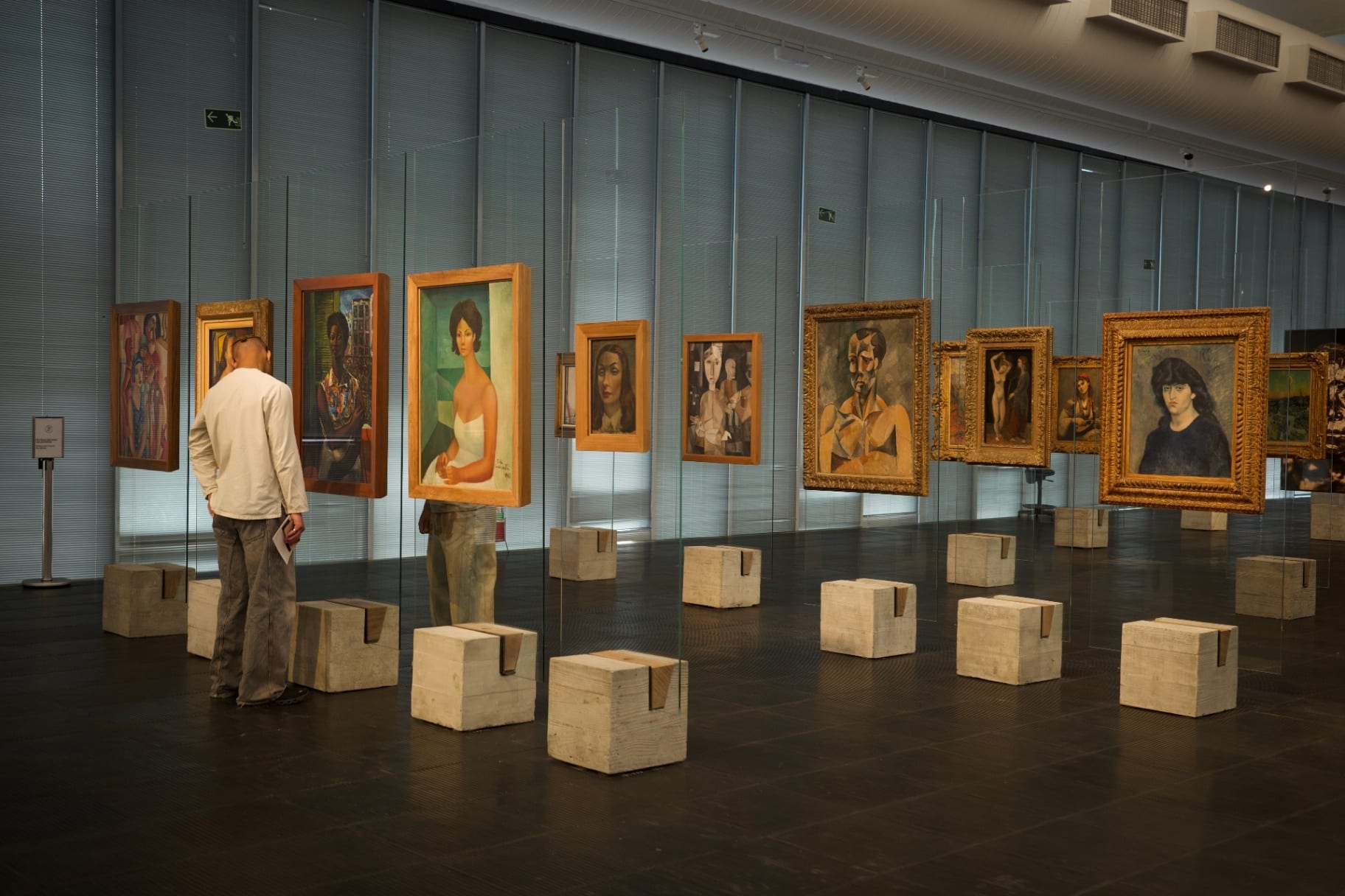 Galeria de retratos suspensos em painéis de vidro